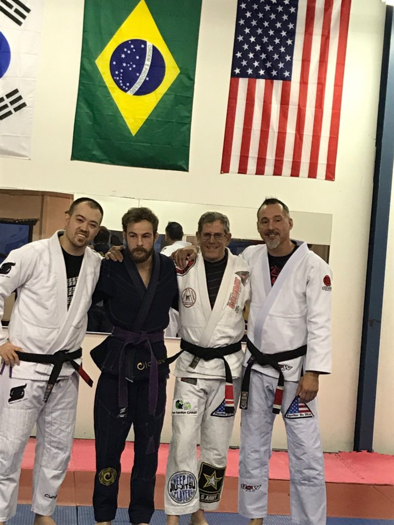 four men in jiu jitsu gis 